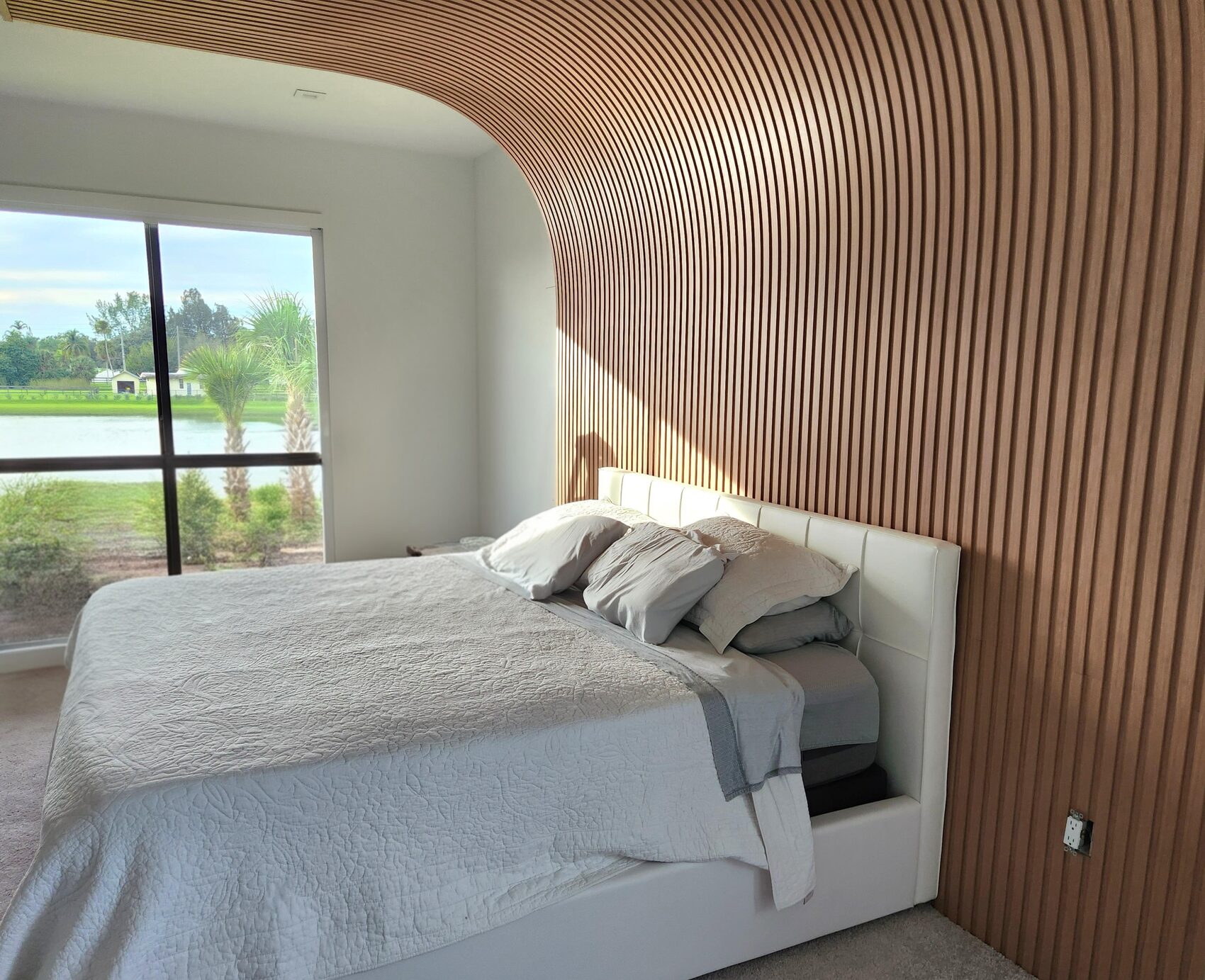 Bedroom with curved wall and a view