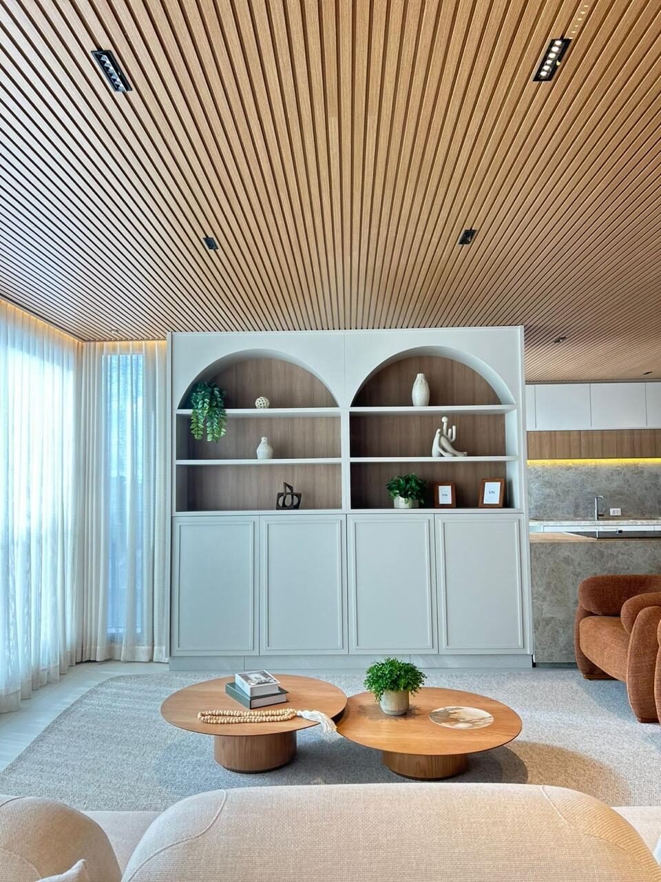 Living room with arched niches and slatted ceiling